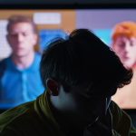 The Shadow of Short-Form Content**
A person, perhaps with a slightly dazed or exhausted expression, endlessly scrolling through a smartphone. The screen displays a rapid, chaotic blur of vibrant short-form videos, while the background around them is dark and blurred, suggesting a loss of time and focus. The overall atmosphere conveys a sense of fleeting stimulation followed by underlying emptiness or fatigue.

**
